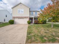 Two-story house with beige siding, brick accents, and a two-car garage at 10436 Waverly Dr, Indianapolis, IN 46234