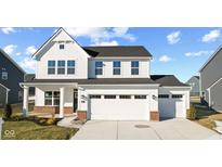 Two-story white house with a brick base, a three-car garage, and landscaping at 258 Mcnair Rd, Whiteland, IN 46184