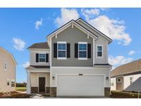 Two-story home with a two-car garage, gray shingles and white siding against a blue sky at 1833 James Pierce Dr, Shelbyville, IN 46176