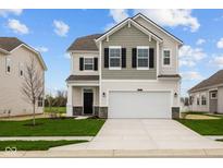 Charming two-story home featuring a gray and white color scheme, a two-car garage, and a well-manicured lawn at 1833 James Pierce Dr, Shelbyville, IN 46176