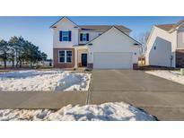 Two-story house with white siding, brick accents, and a two-car garage at 1042 Stubble Run, Danville, IN 46122