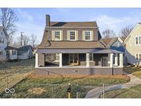 Charming two-story home featuring a covered front porch and brick facade at 1429 Brookside Pkwy N Dr, Indianapolis, IN 46201