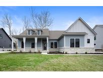 Charming single-Gathering home featuring stone accents, gray siding, covered entry, and a well-manicured lawn at 1433 Chatham Hills Blvd, Westfield, IN 46074