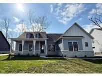 Charming single-Gathering home showcasing stone accents, a covered porch, and a well-manicured lawn on a sunny day at 1433 Chatham Hills Blvd, Westfield, IN 46074