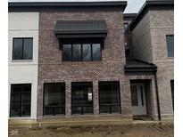 Brick townhouse exterior with modern metal roofing and large windows at 11896 Spring Mill Rd, Carmel, IN 46032