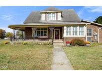 Brick house with a wraparound porch and landscaped yard at 232 N Church St, Morgantown, IN 46160