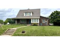 Charming brick home with a well-maintained lawn and classic architectural details at 232 N Church St, Morgantown, IN 46160