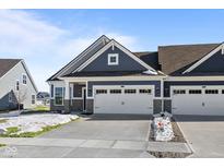 Charming home featuring stone accents, a two-car garage and stylish blue siding at 3537 Wrangler Dr, Bargersville, IN 46106
