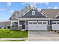 Charming home featuring a gray facade, a two-car garage, and a well-manicured front lawn at 3537 Wrangler Dr, Bargersville, IN 46106