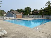 Community pool featuring lounge chairs and a bright blue swimming area for relaxing and enjoying the outdoors at 8168 Shorewalk Dr # A, Indianapolis, IN 46236