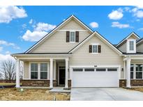Beautiful home exterior showcasing neutral siding, dark shutters, and a two-car garage at 18425 Depoe Ln, Westfield, IN 46074