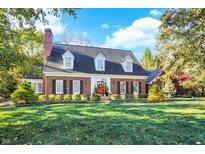 Brick home with a charming front porch and well-manicured lawn at 10931 Fawn Lake Dr, Indianapolis, IN 46278