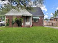 Charming brick home with well-maintained lawn and classic architectural details at 3305 N Keystone Ave, Indianapolis, IN 46218