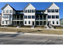 Newly constructed townhomes featuring charming front porches and modern architectural details at 468 W Smoky Row, Carmel, IN 46032