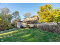 Charming two-story house with a wraparound porch, nestled on a spacious grassy lot at 7709 Elk Dr, Nineveh, IN 46164