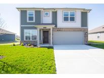 Charming two-story home featuring a manicured lawn, two-car garage, and welcoming front door at 1217 Fleming Dr, Greenfield, IN 46140