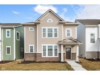 Two-story home featuring neutral siding, brick accents, and a welcoming front porch at 12001 Gia Ct, Noblesville, IN 46060