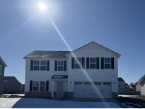 Two-story house with white siding, gray roof, and a three-car garage at 1323 Salisbury Dr, Greenfield, IN 46140