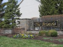 Stone monument sign for The Bristols community with landscaping and wrought iron fence at 12912 Broncos Dr, Fishers, IN 46037