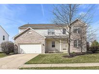 Charming two-story home featuring brick accents, a two-car garage, and a well-maintained lawn at 12912 Broncos Dr, Fishers, IN 46037