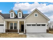 Inviting home with a two-car garage, dormer windows, and brick accent, offering both curb appeal and practicality at 18415 Depoe Ln, Westfield, IN 46074