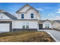 New construction home featuring a white exterior, dark brick foundation, and manicured yard at 251 Hunters Ridge Dr, Danville, IN 46122