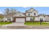 Charming two-story home featuring a brick facade, manicured lawn, and attached two-car garage at 251 Hunters Ridge Dr, Danville, IN 46122