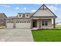 Charming brick home with a spacious three car garage and well-manicured lawn at 5005 Carmine St, Brownsburg, IN 46112