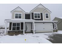 Two-story home with two-car garage featuring stone accents and covered porch in winter landscape at 4180 Bozeman Way, Bargersville, IN 46106