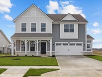 Charming two-story home features a two-car garage, covered porch, and well-manicured lawn at 4193 Bozeman Way, Bargersville, IN 46106