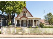Charming two-story home featuring a large front porch and a white picket fence at 741 Greer St, Indianapolis, IN 46203