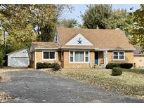 Brick ranch house with attached garage, autumn leaves, and a welcoming front porch at 1120 Southwood Dr, Indianapolis, IN 46227