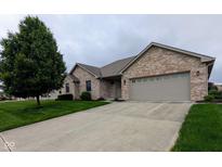 Charming brick home with a well-manicured lawn and a two-car garage, set on a cloudy day at 3784 Mansfield Dr, Brownsburg, IN 46112