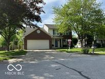 Charming two-story home with a brick facade, a well-maintained lawn, and mature trees at 534 Austrian Way, Avon, IN 46123