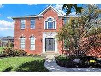 Charming two-story brick home with a landscaped yard, gray door, and an inviting walkway to the front door at 794 Princeton Ln, Westfield, IN 46074