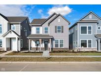 Two-story home with gray and white siding, stone accents, and a covered porch at 816 James William Ln, Westfield, IN 46074