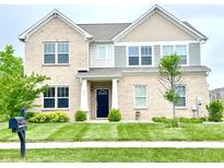 Charming two-story brick home featuring a well-manicured lawn and a welcoming entrance at 5778 W Commonview Dr, McCordsville, IN 46055