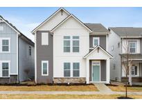 Two-story home with gray and white siding, light green door, and stone accents at 810 James William Ln, Westfield, IN 46074