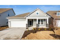 Charming single-story home with gray siding, white trim, and a two-car garage at 14293 Coyote Ridge Dr, Noblesville, IN 46060