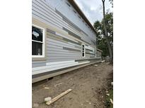 New construction home showcasing a modern exterior with multi-toned siding at 1924 N Lesley Ave, Indianapolis, IN 46218