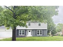 Charming two-story home with gray siding, dark brick accents, white trim, and a well-manicured lawn at 839 Fernwood Ct, Indianapolis, IN 46234