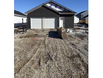 New construction home exterior with a two-car garage and gravel driveway at 1439 Wigwam Ln, Martinsville, IN 46151