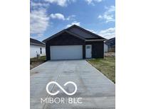 Charming single-story home with a front-facing two-car garage and concrete driveway at 1439 Wigwam Ln, Martinsville, IN 46151