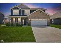 Beautiful two-story home with manicured lawn and a two-car garage at 1775 Beyers St, Fortville, IN 46040