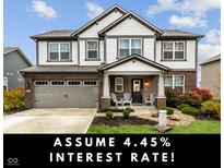 Charming two-story home featuring a landscaped front yard, covered porch, and a two-car garage at 3680 Drummore Pl, Bargersville, IN 46106