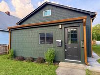 Charming home featuring unique shake siding, updated gutters and a well-maintained front yard at 1621 Draper St, Indianapolis, IN 46203