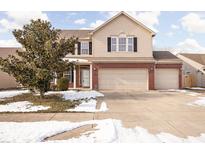 Two-story house with beige siding, brick accents, and a two-car garage at 2206 Rosswood Blvd, Indianapolis, IN 46229