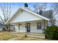 Charming single-story home featuring a covered porch and a well-maintained front yard at 825 Arrow Ave, Anderson, IN 46016