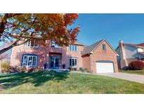 Stunning two-story red brick home with attached garage, lush lawn, and vibrant fall foliage at 1160 Mt Vernon Dr, Greenwood, IN 46142