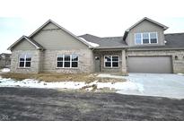 Two-story craftsman home with brick and siding exterior, two-car garage, and front entry at 2331 Saddle Dr, Shelbyville, IN 46176